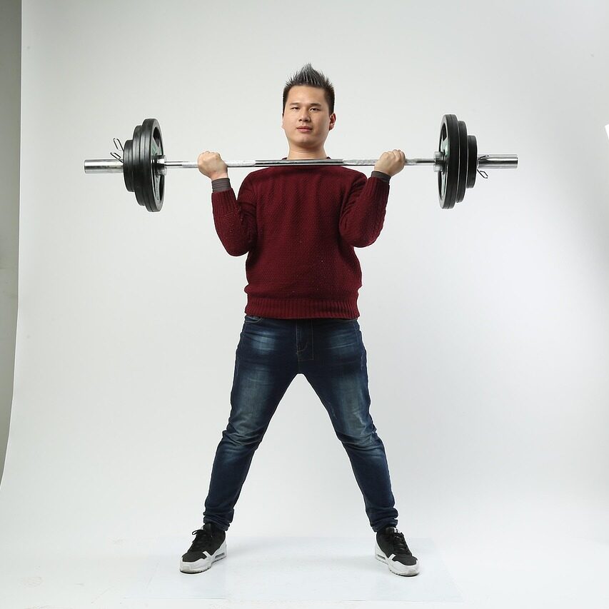 Home Page Man Lifting Barbell Jeans