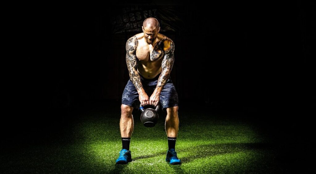 Man performing kettlebell swings
